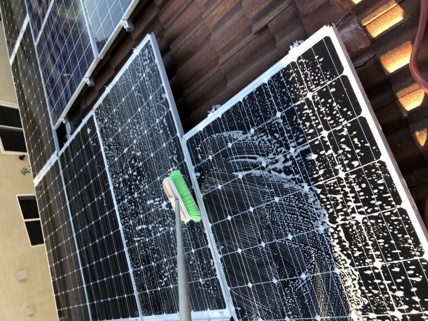 Using a mop to clean solar panels